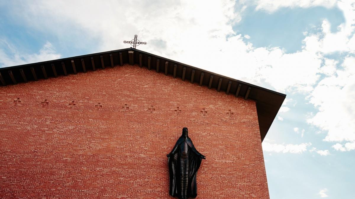 Building brick wall with a religious figure on it
